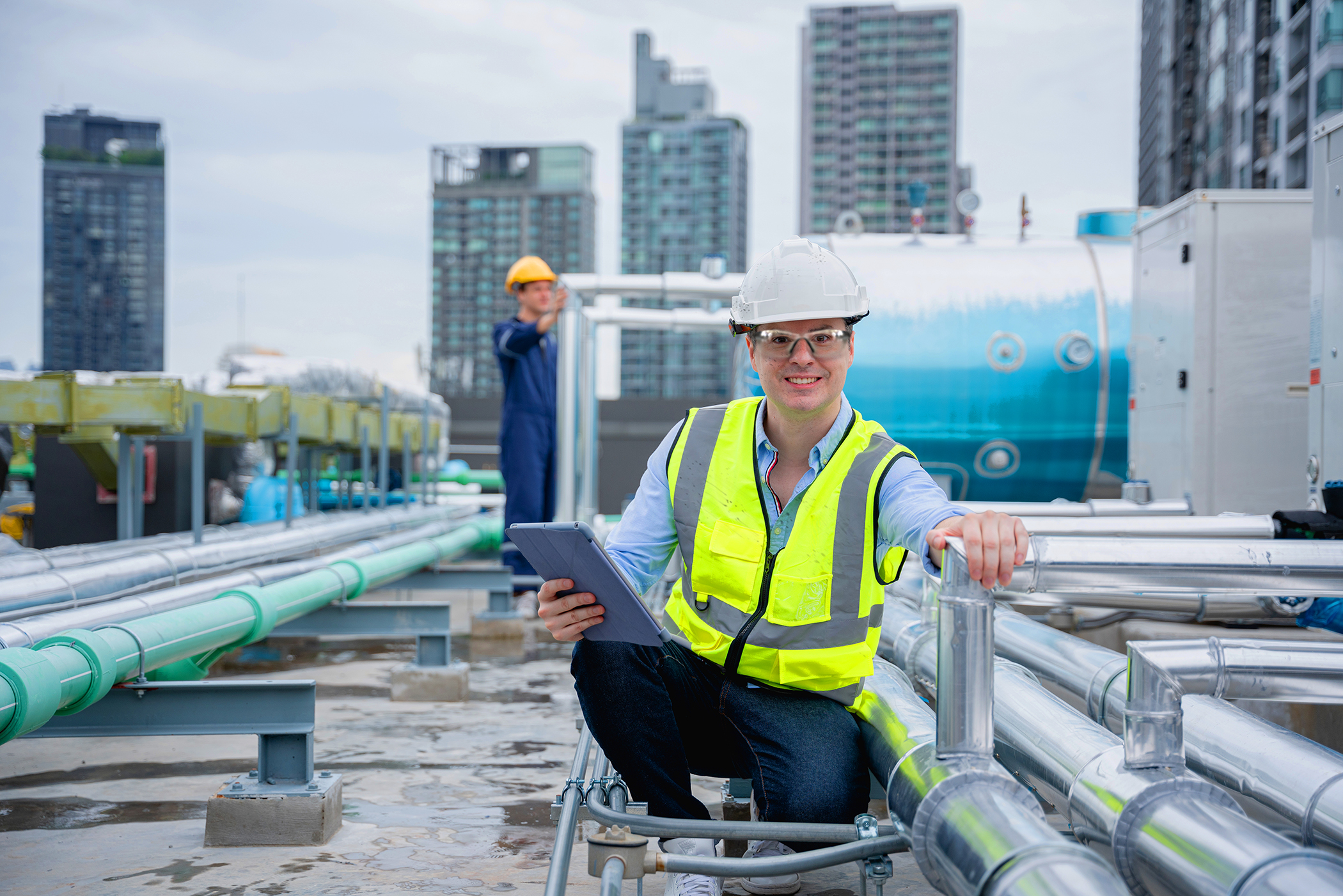 A team of engineers is checking the air conditioning cooling system of a major building or industrial facility.